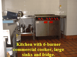 Kitchen with 6-burner
commercial cooker, large
sinks and fridge.